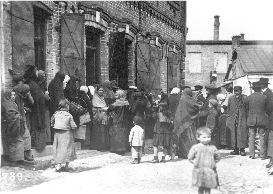 East European villagers lining up for food